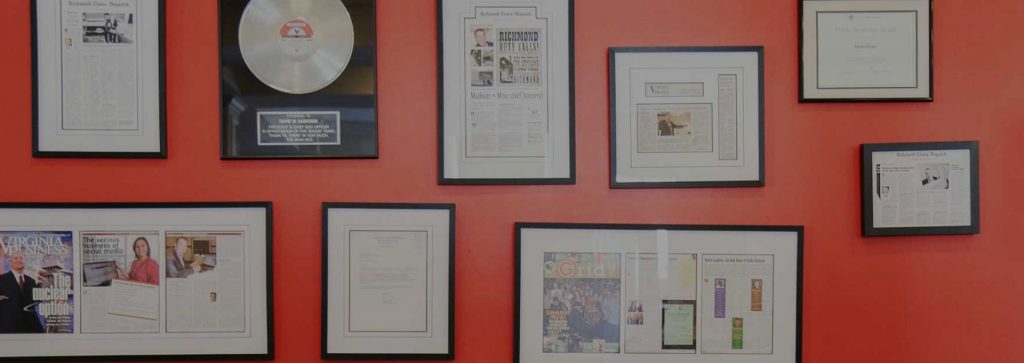 Wall containing framed news articles